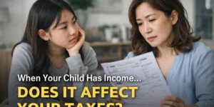 Real-life photo of an Asian mother and her teenage daughter reviewing a tax form at home, illustrating how a child’s income can affect parents’ taxes in 2025